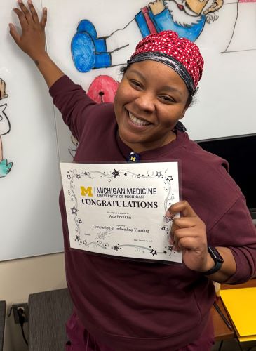 Asia Franklin with her certificate qualifying her to perform peripheral line blood draws.